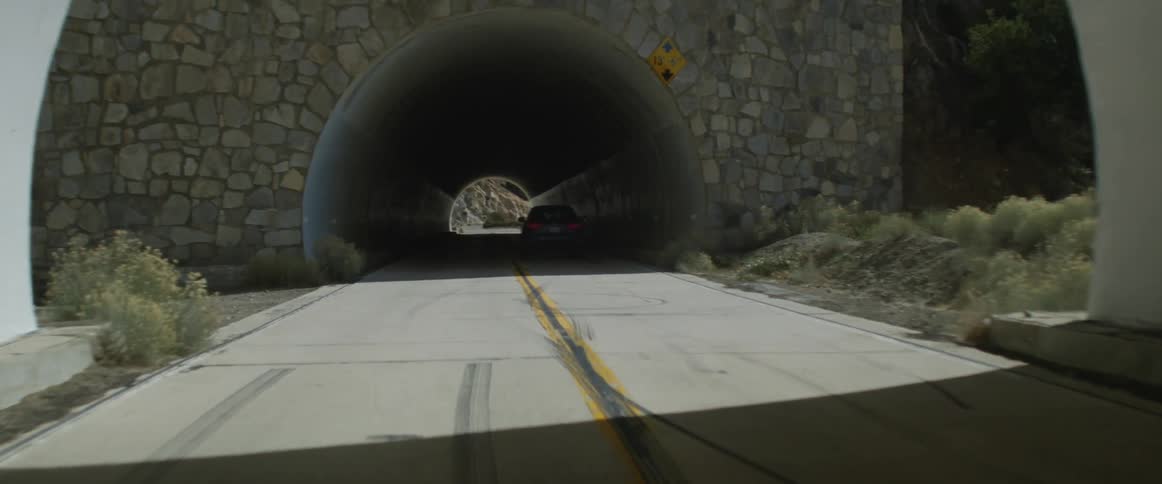 Blue car drives through tunnels