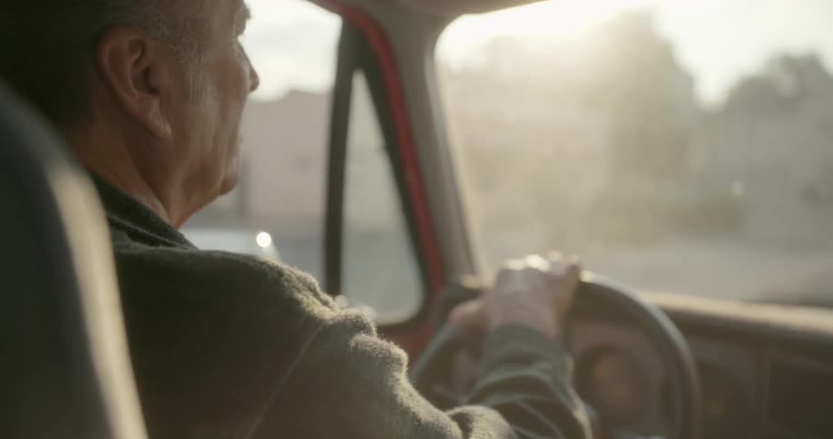 A man is driving through town