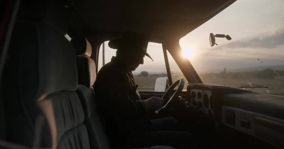 A man gets into the vehicle and starts it