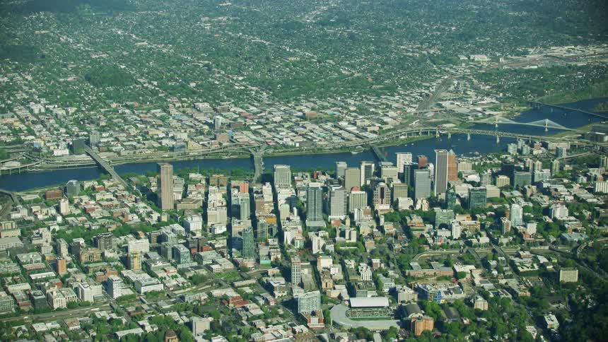 The downtown grid of Portland Oregon as seen from high above as the Willamette River weaves through the metro area and the southeast neighborhoods below