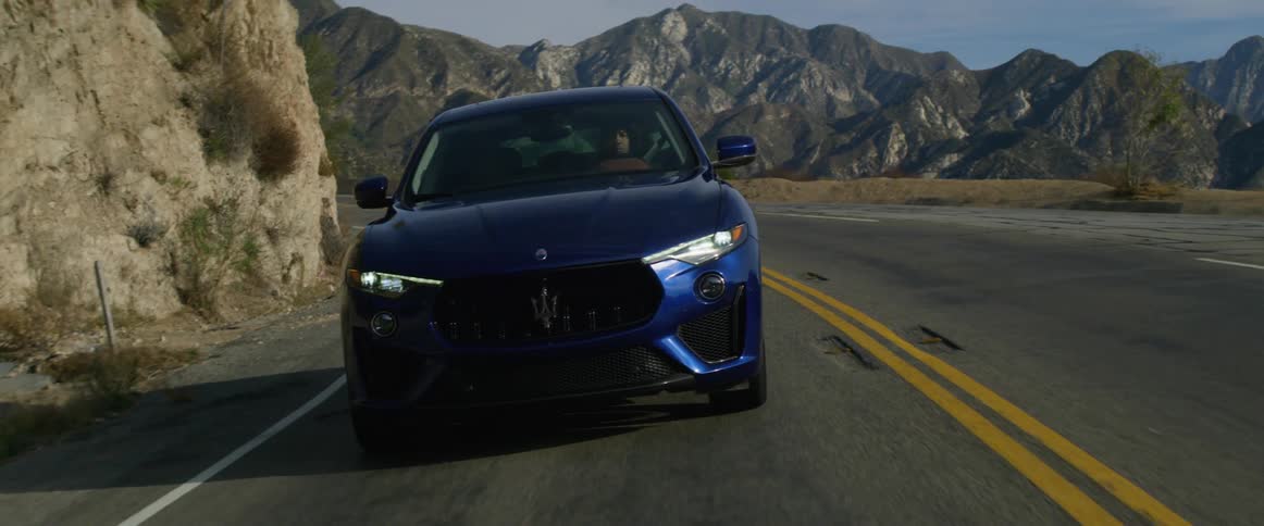 A person is driving near the mountains