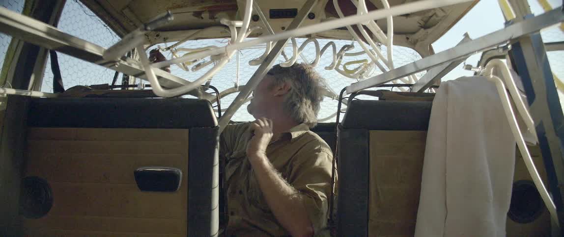 A man is working in a van on a sunny day