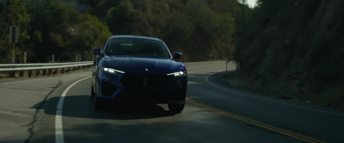 A vehicle driving on a road in the middle of the day