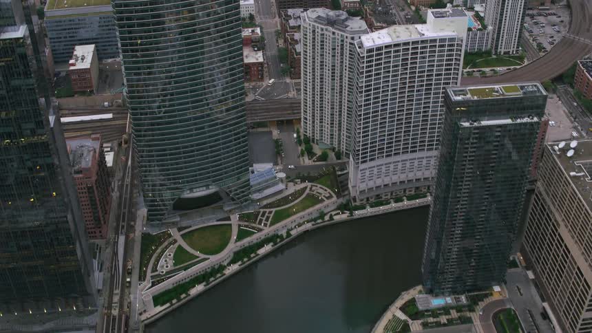 A river runs through a city as vehicles travel on the city streets