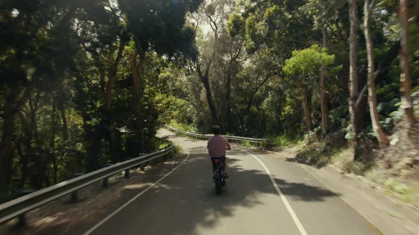 A person is riding their electronic bike on the trail