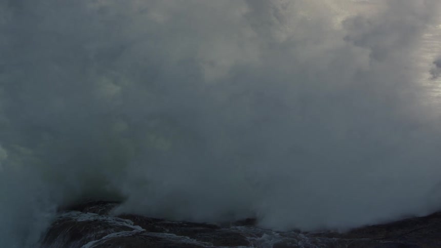 Ocean waves crash over the rocks