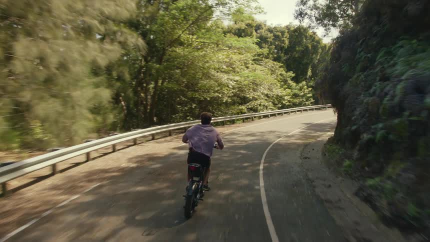 A man rides a bike down the trail