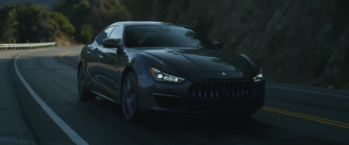 A car driving down a road in the day