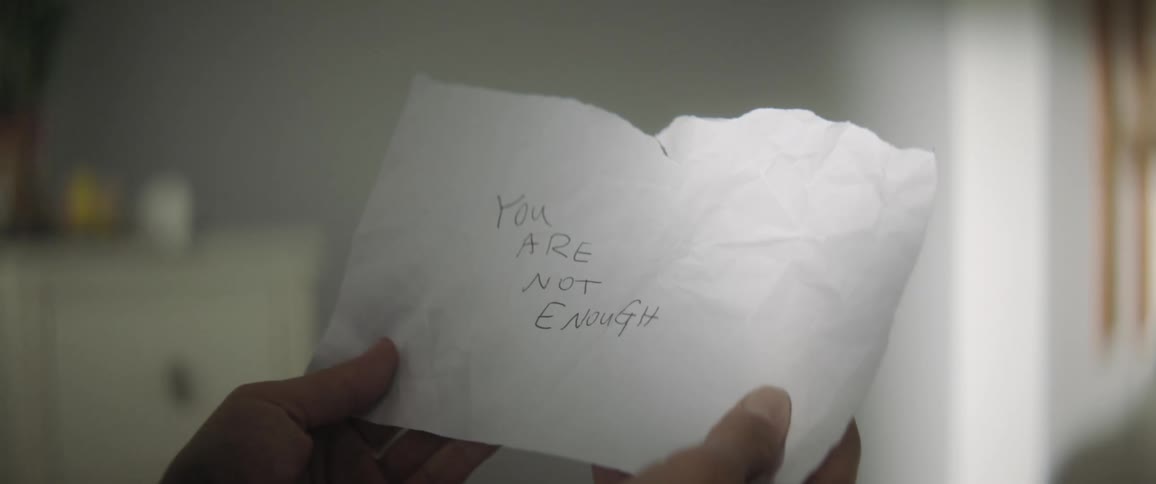 A person opening a note with a rude and discouraging remark