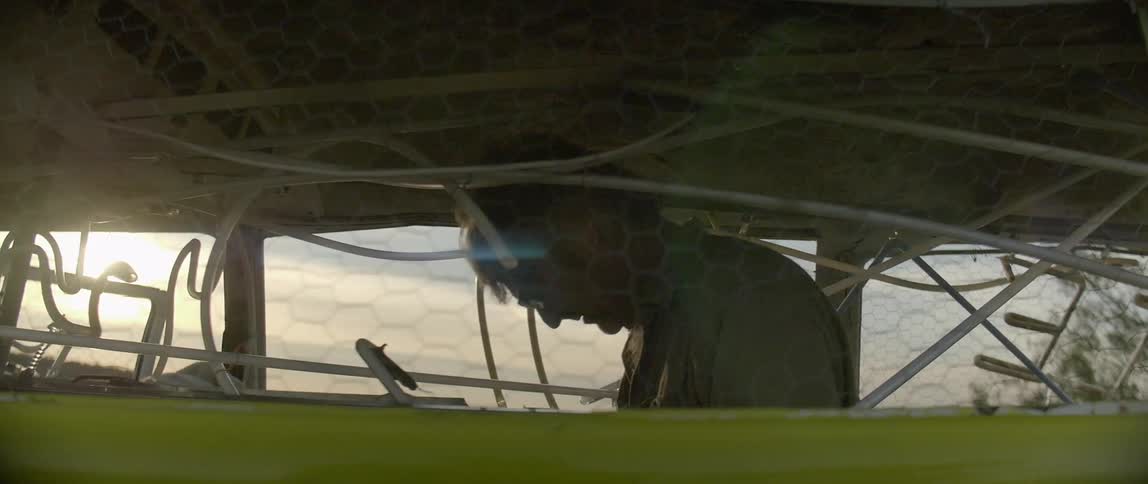 A man is in a van working at sunset