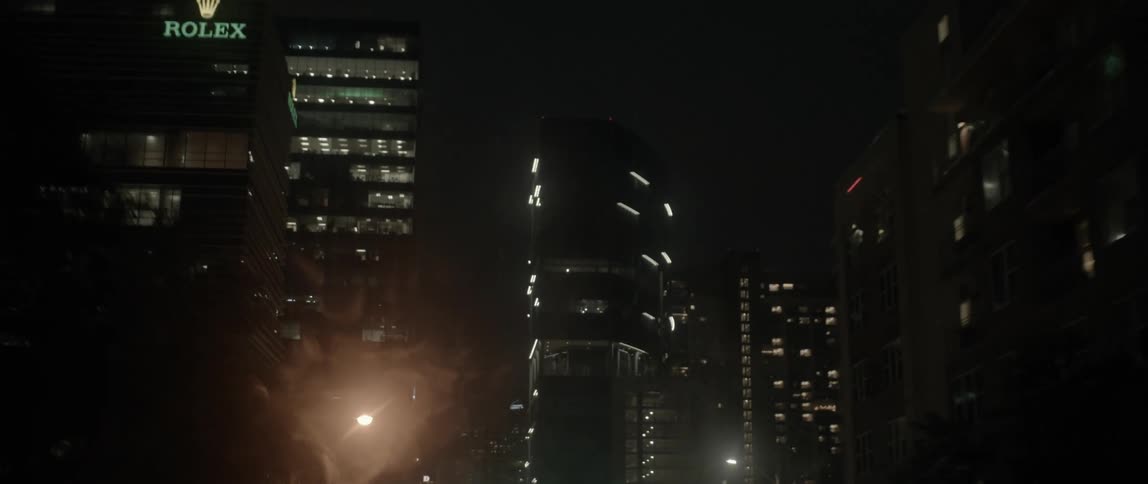 Skyscrapers in a dense downtown are lit up at night