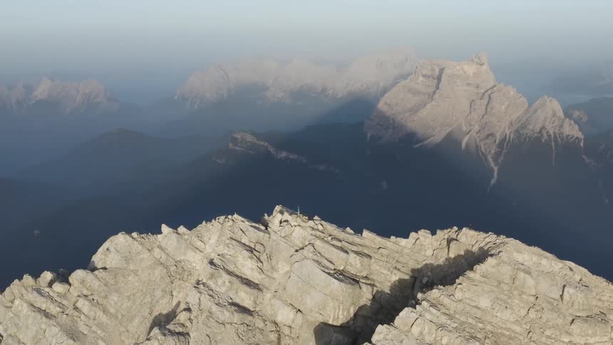 Dense fog forms over steep mountains