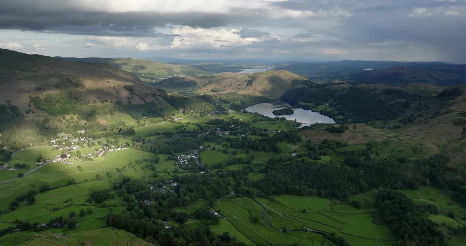 Aerial view of a small town near a lake inside a valley beween mountains