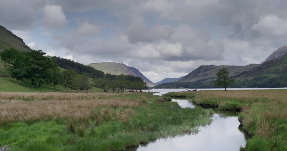 A landscape view with a river in front of hills