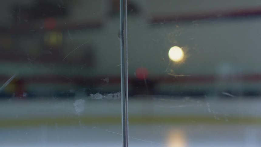 A zamboni drives across an ice rink
