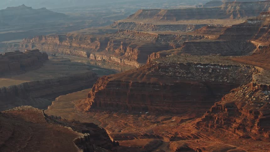 A stair like pattern forms along the sides of a vast canyon