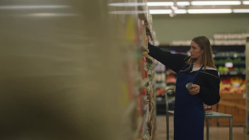 The girl is stocking the shelves