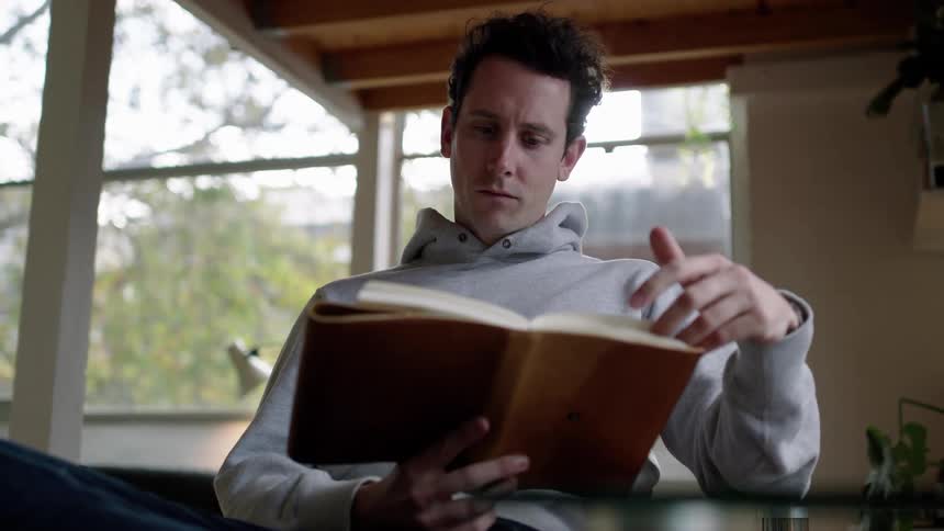 A man reading a book in a room
