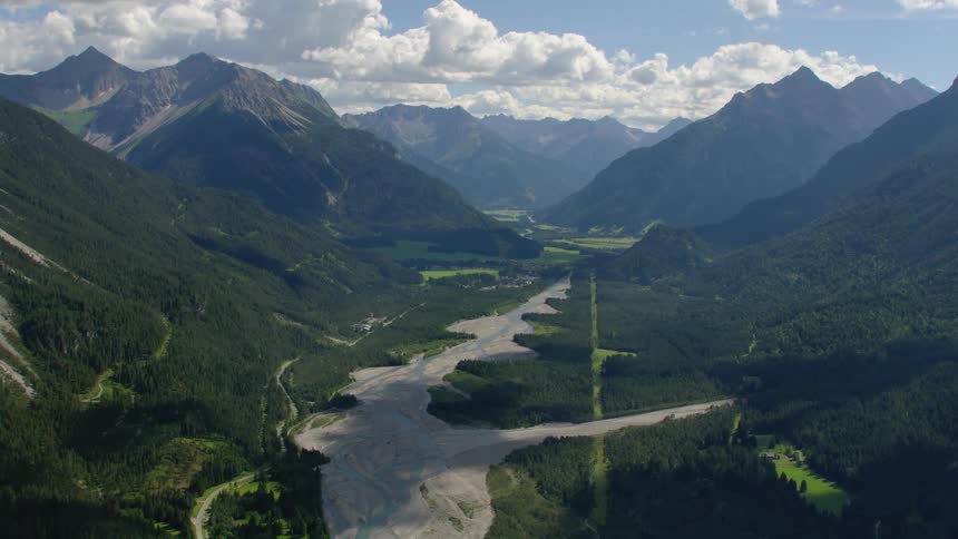 Aerial view of valley river with mountain forest