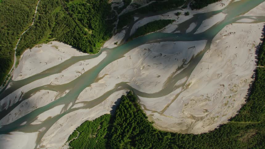 Aerial view of the sand banks on the river bed surrounded by pine tree forests