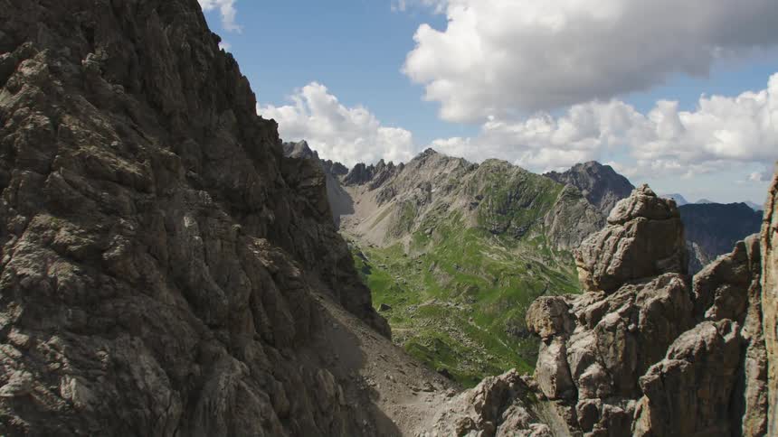 Aerial view of steep mountains and green valley