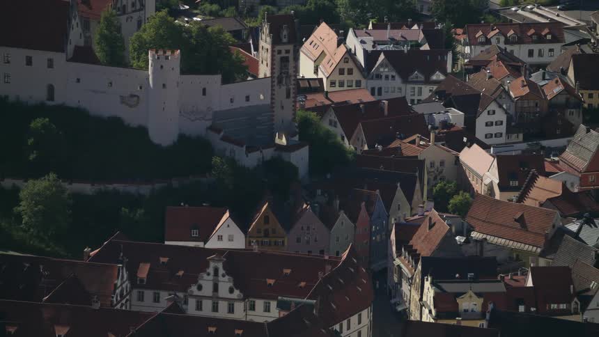 A crowded town contains many buildings with older european architecture