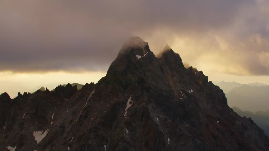 Aerial view of steep mountains under clouds
