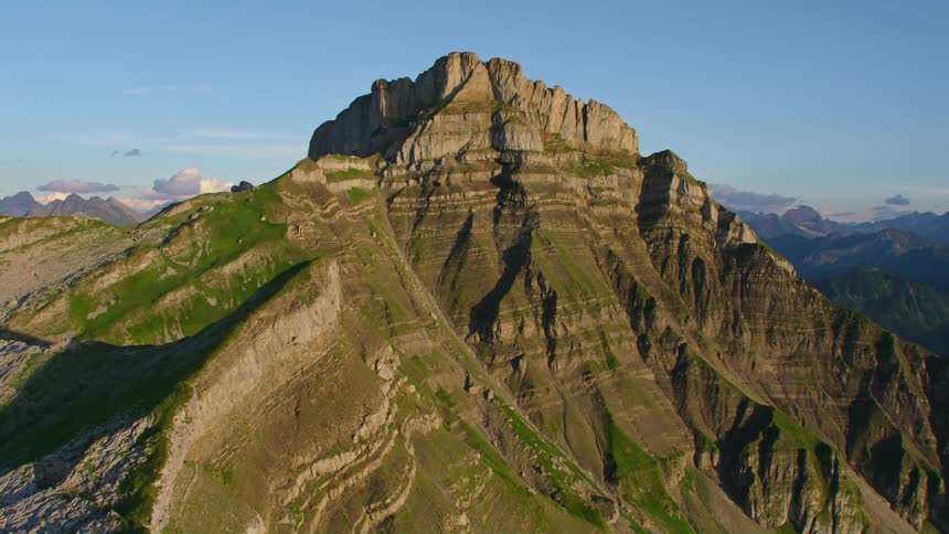 Aerial view of the rugged slopes of a mountain peak at morning