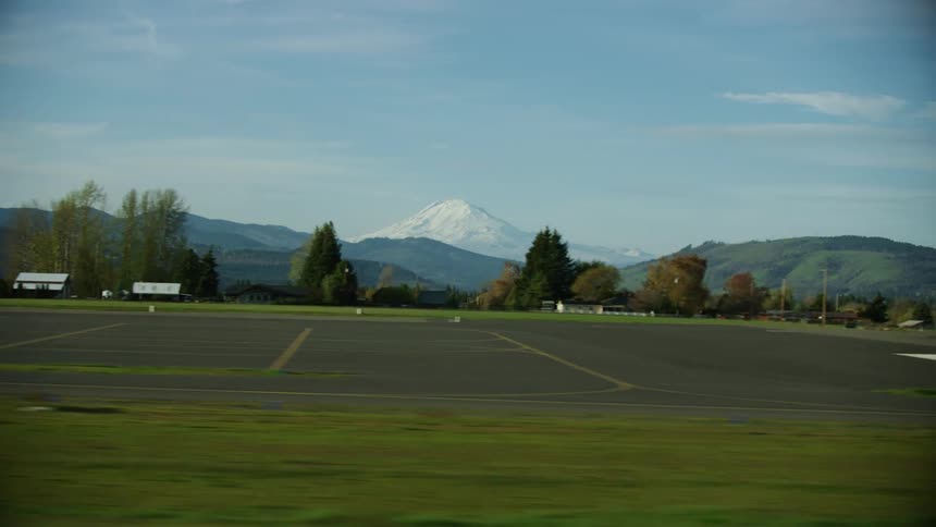 Passenger landing POV looking out the window at a small airport in rural Oregon looking at Mount Adams in Washington State