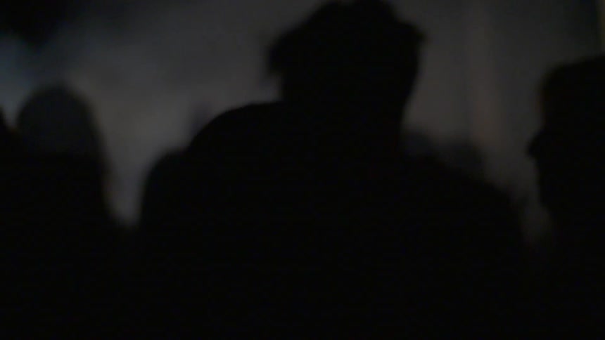 A crowd of people in a dimly lit space
