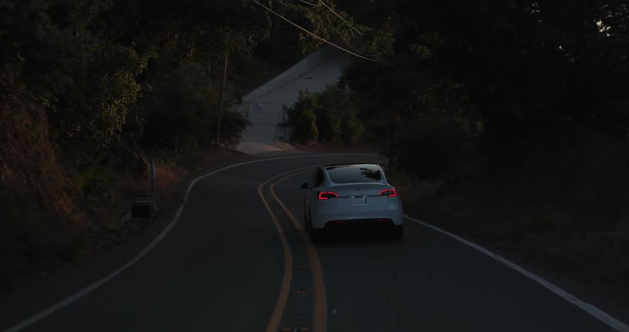 A car drives down a winding road