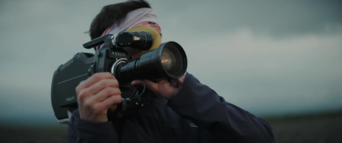 A person with a big camera outdoors