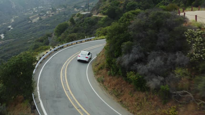 A car drives down a winding road