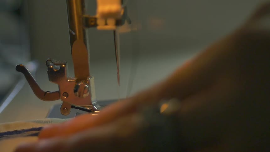 Fabric is being fed into a sewing machine