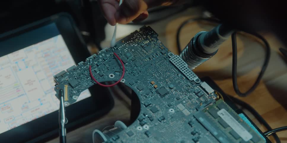 A person is cleaning some machine at there workplace