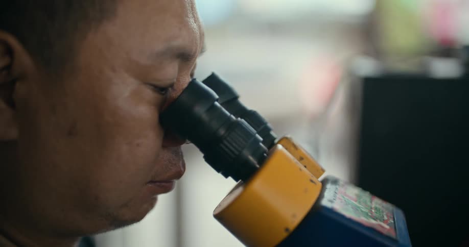 A man using a microscope