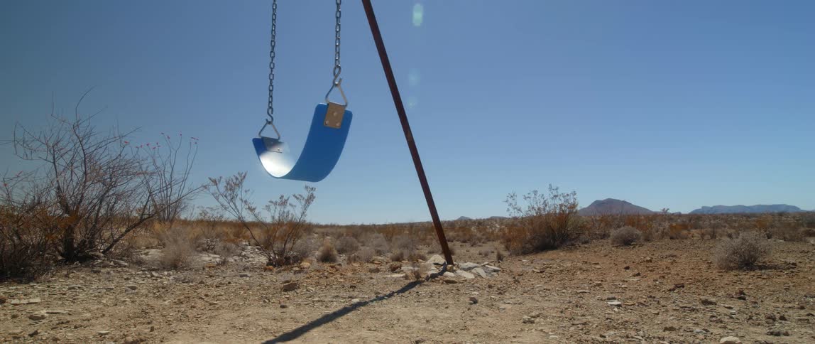 A view of a swing outdoors in the desert