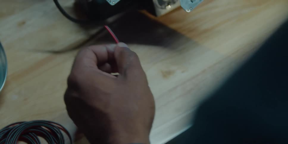 A person is stripping wires