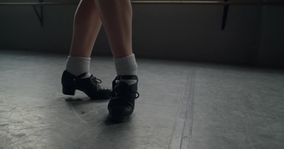Female dance lands a short jump then races one foot onto point