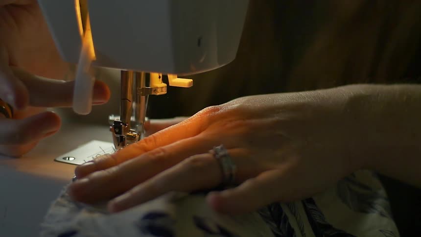 Fabric is being fed through a sewing machine