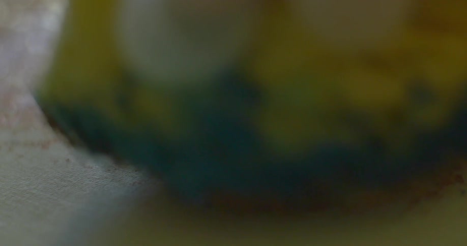 A person applies paint with a sponge