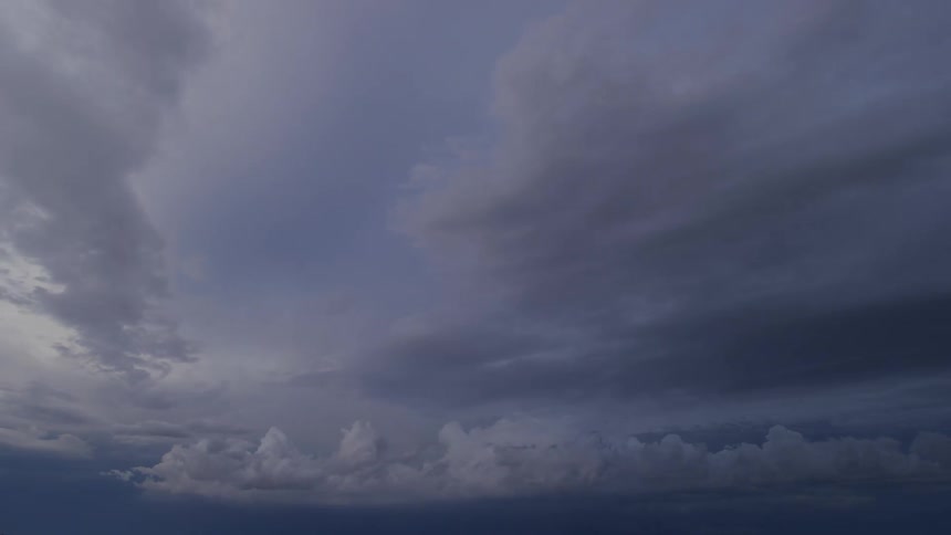 A time lapse shows clouds pass overhead above as the setting sun lights up the entire scene for a fleeting moment