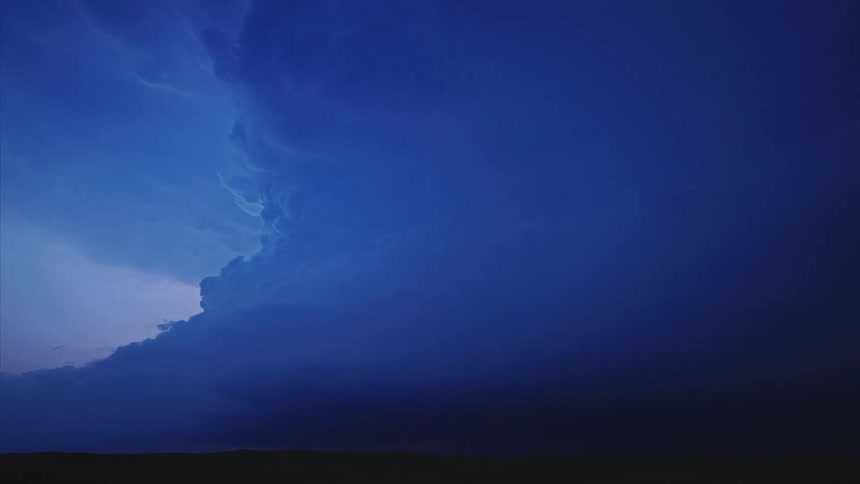 A massive rotating supercell storm time lapse of lightning flashing before the storm overwhelms the picture