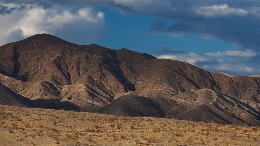 Time lapse of clouds moving over a mountain