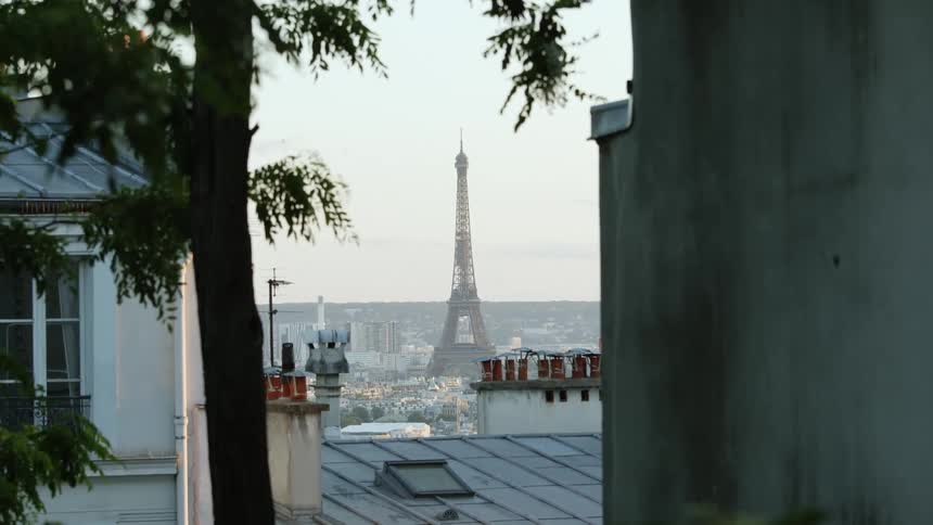 View of eiffel tower with a wroughtiron lattice tower on the champ de mars seen from apartment building in paris
