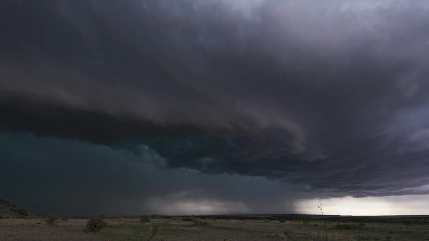 A rolling storm front approaches in this time lapse of severe storm weather at sunset in the American desert