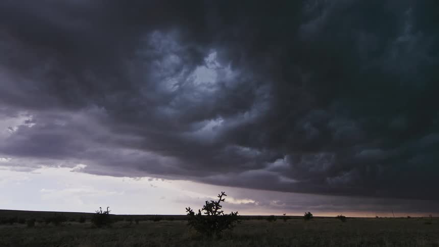 Time lapse of dark storm clouds passing overhead in the American southwest desert