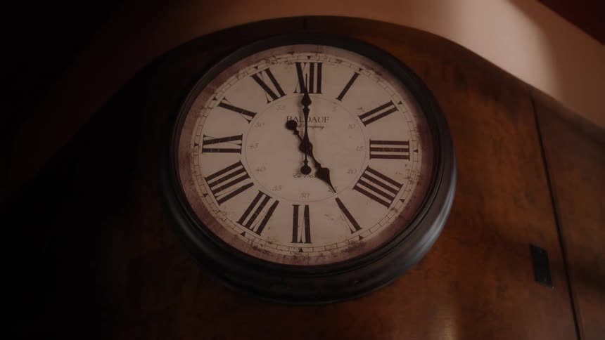Clock with roman numerals hangs at wall in cafeteria