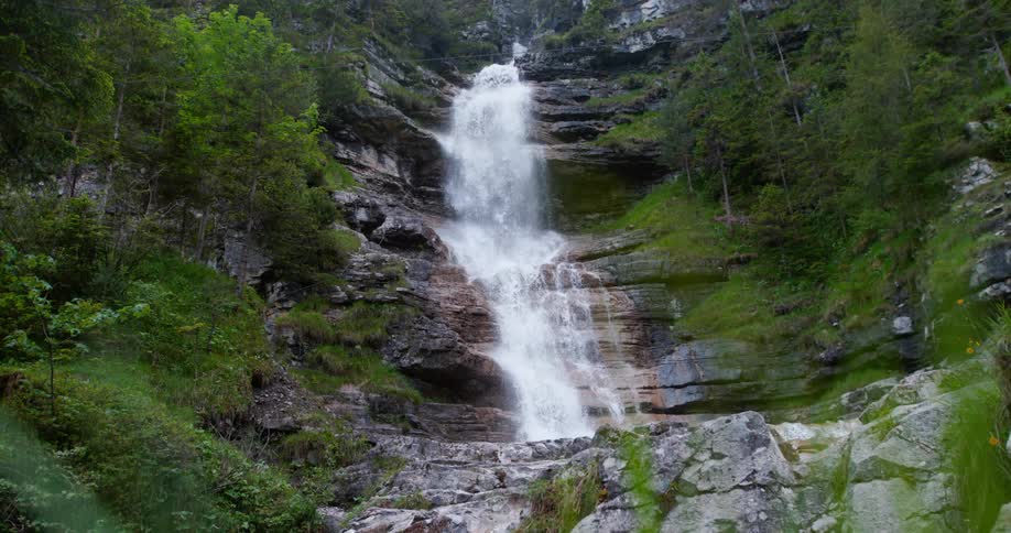 A waterfall runs down the side of a canyon