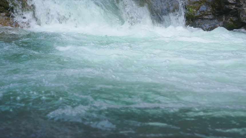 Waterfall cascades down the mountainside